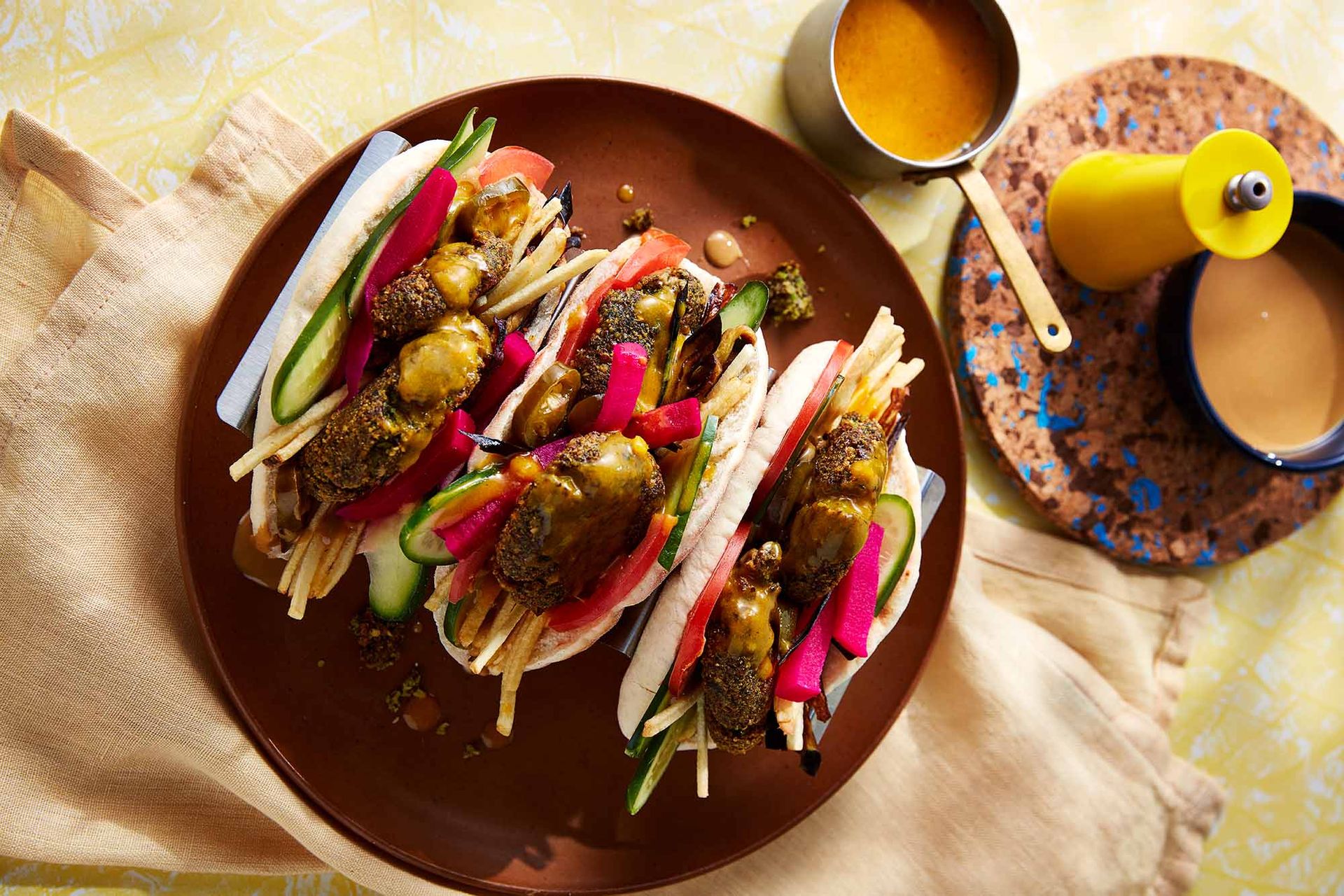 Three falafel sandwiches on a plate