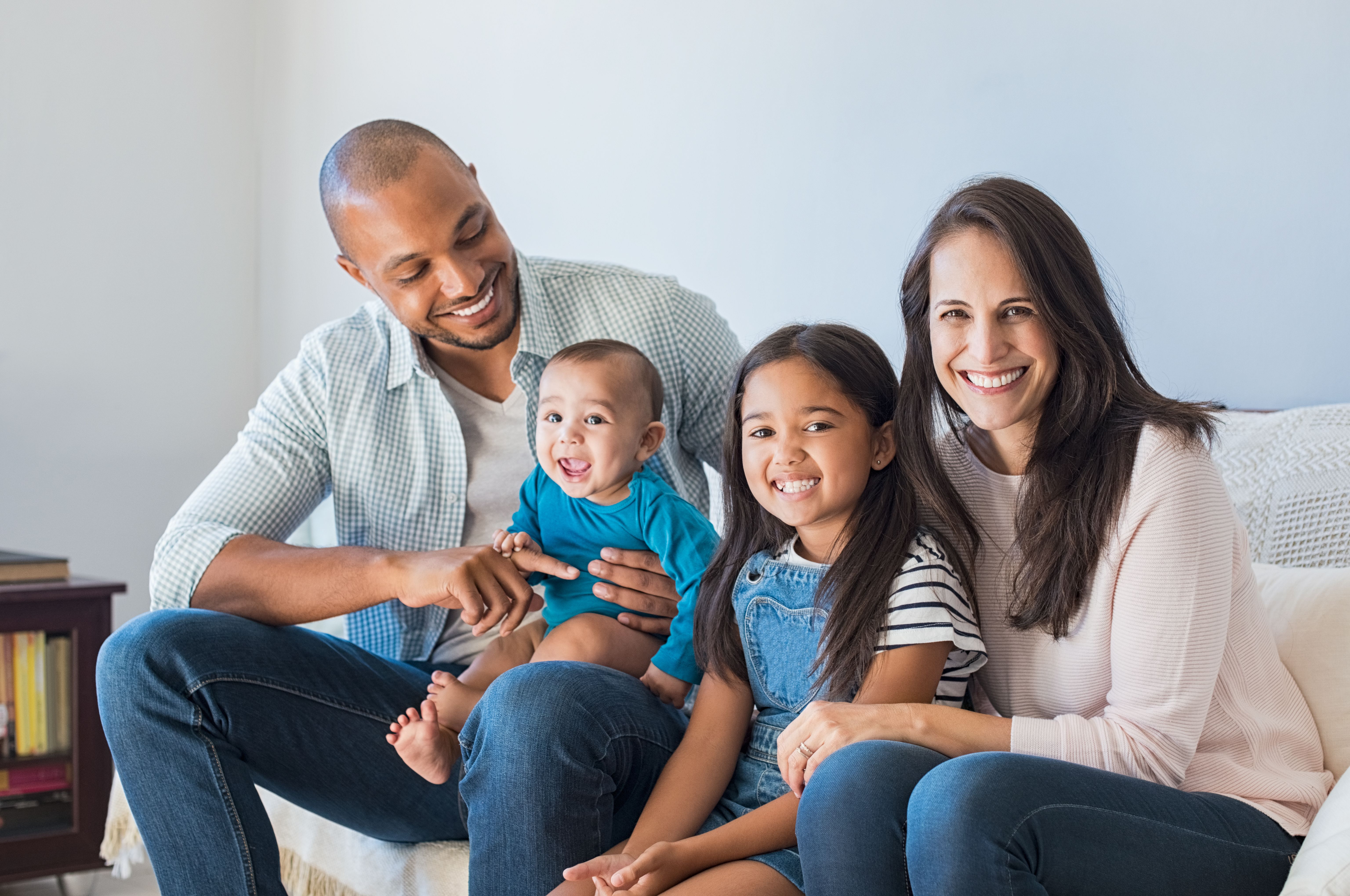 Family with kids sitting on couch