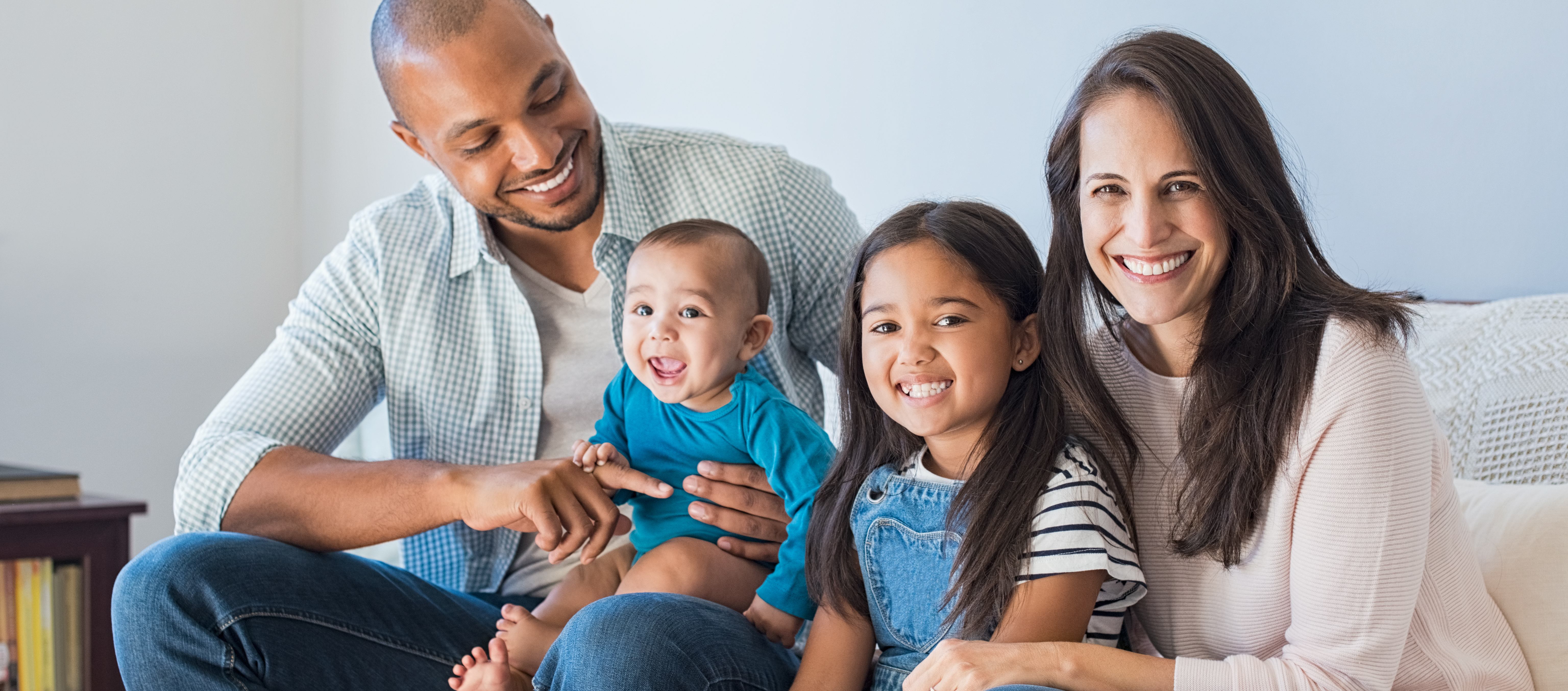 Family with kids sitting on couch