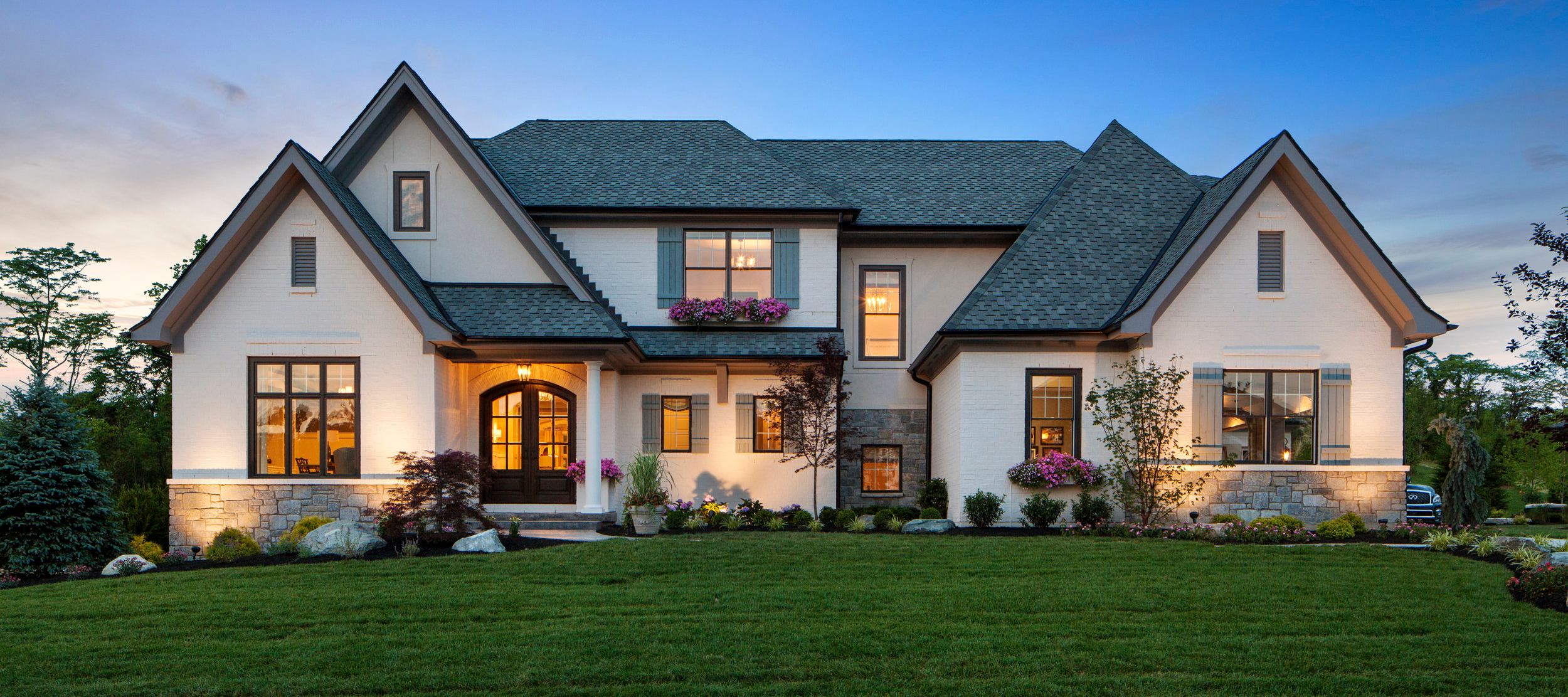 Large house with pointed roofs and many windows