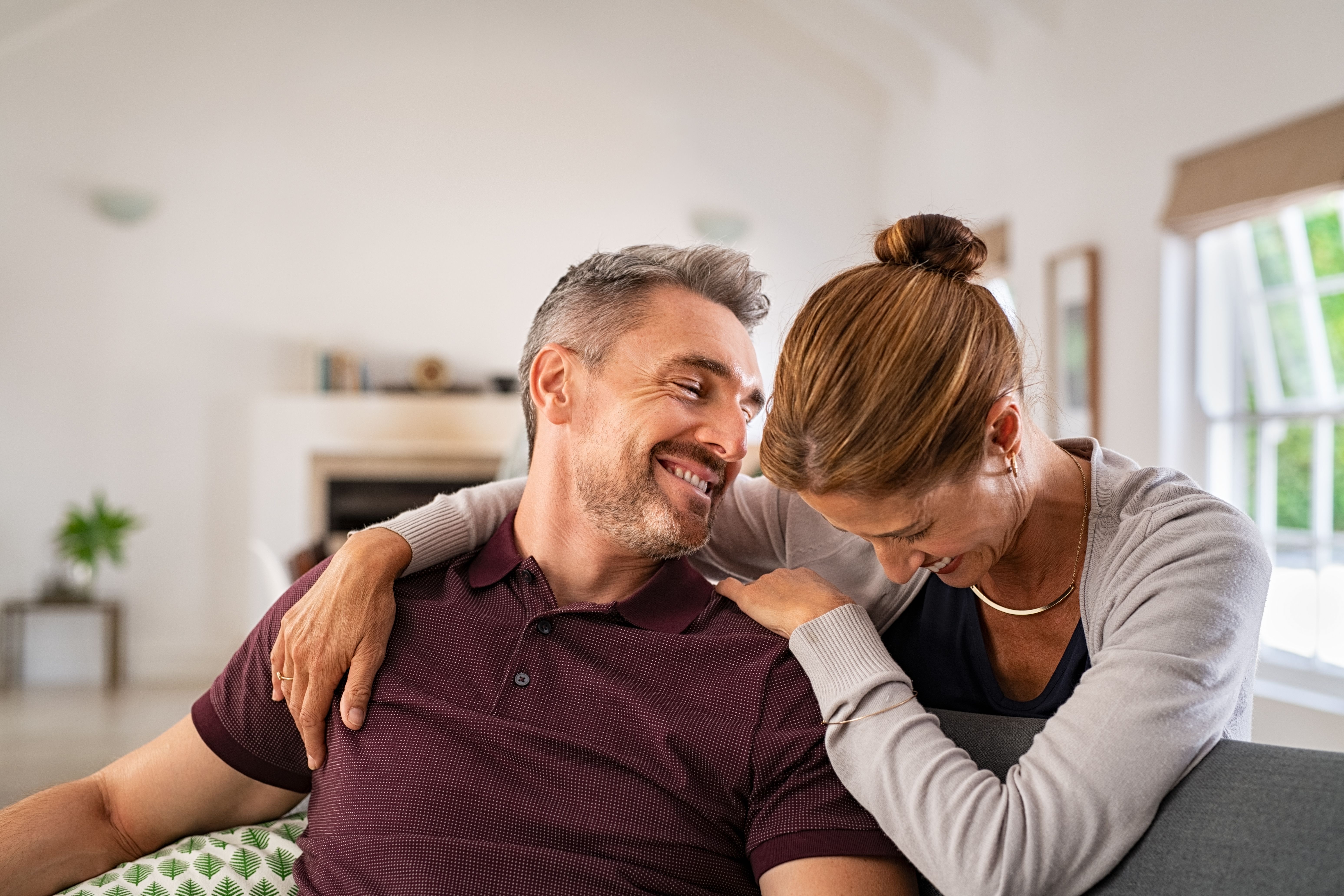 Couple laughing together on couch