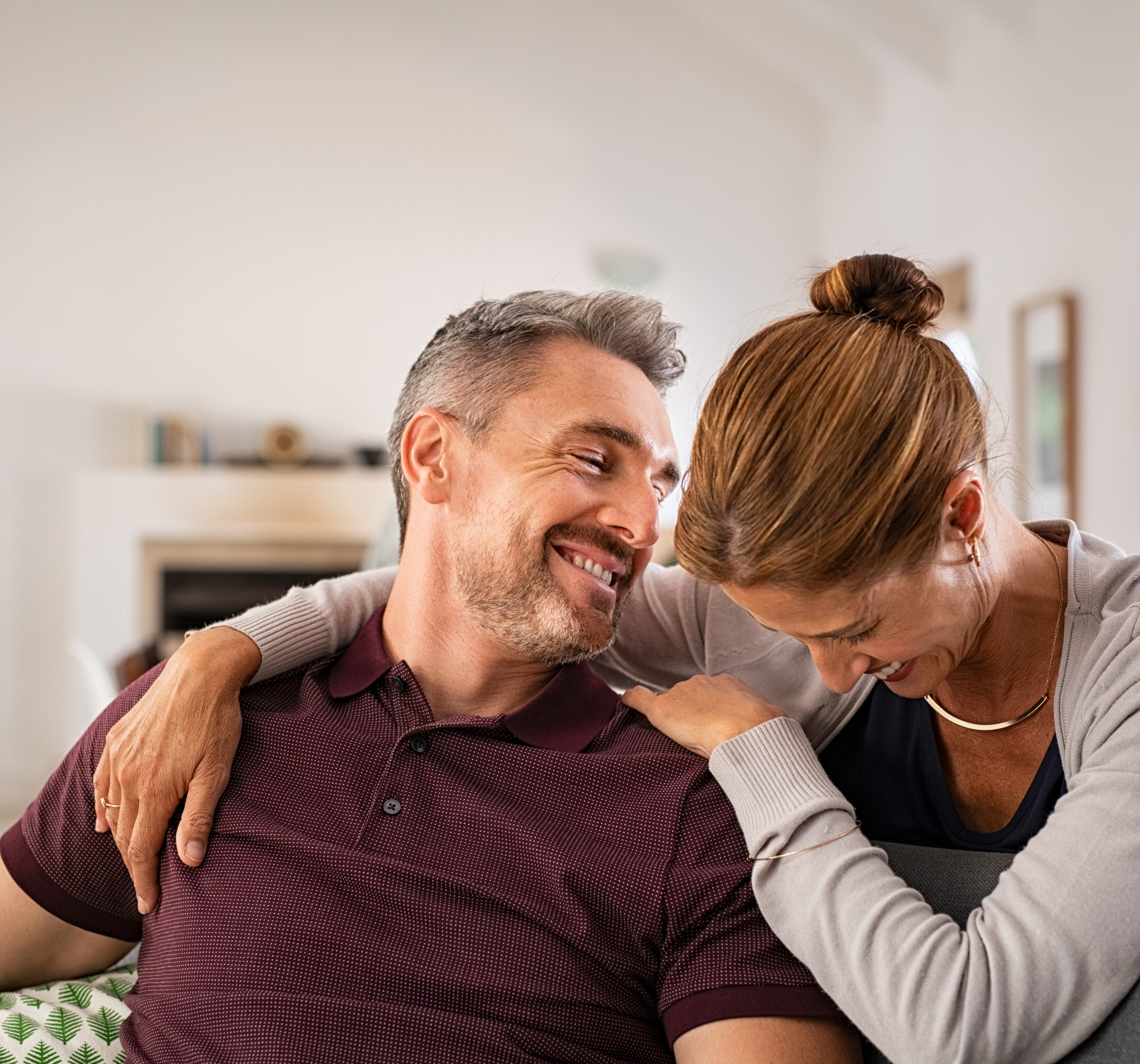 Couple laughing together on couch