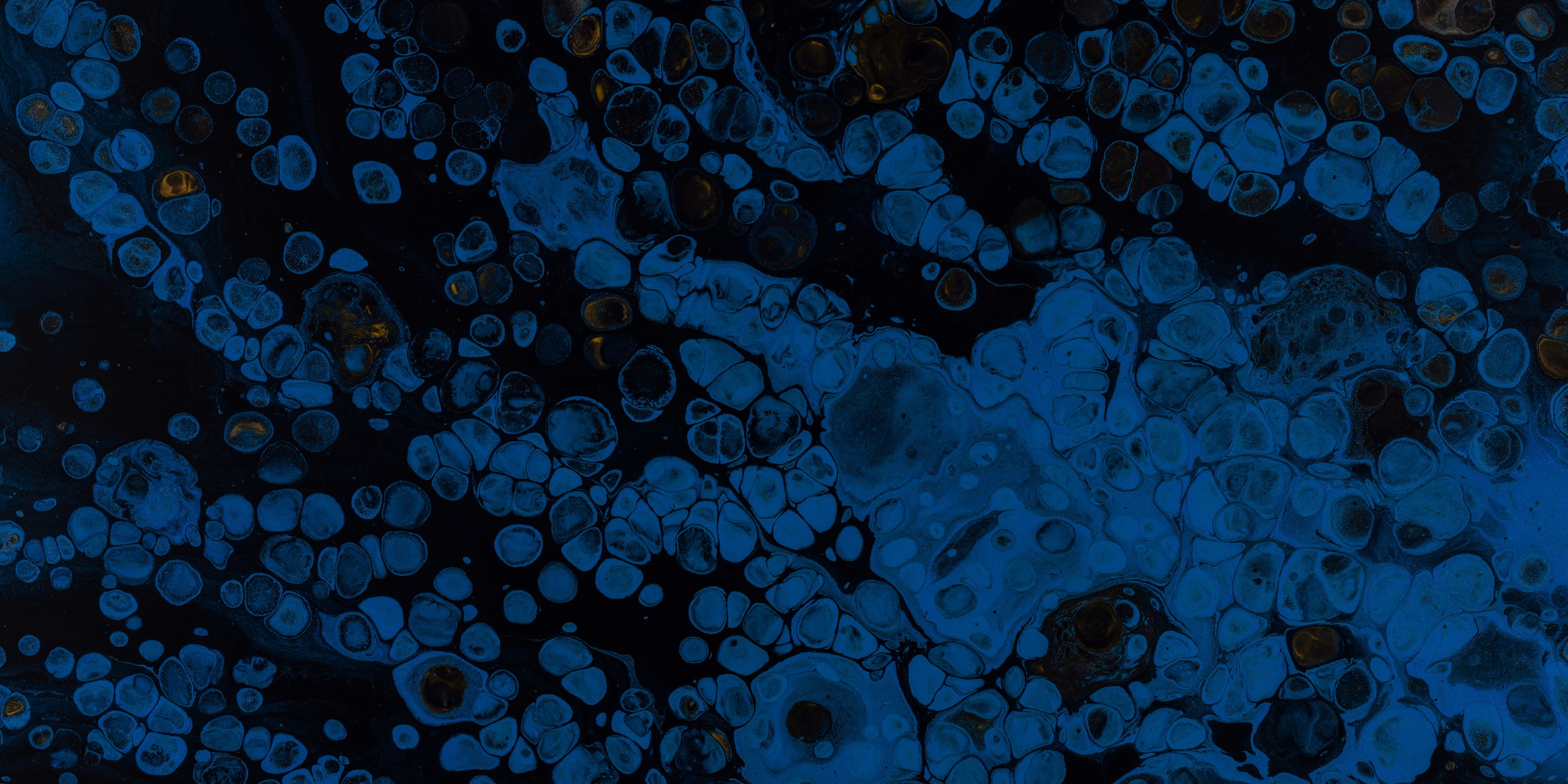 A close up of a blue and black bubbles on a black background