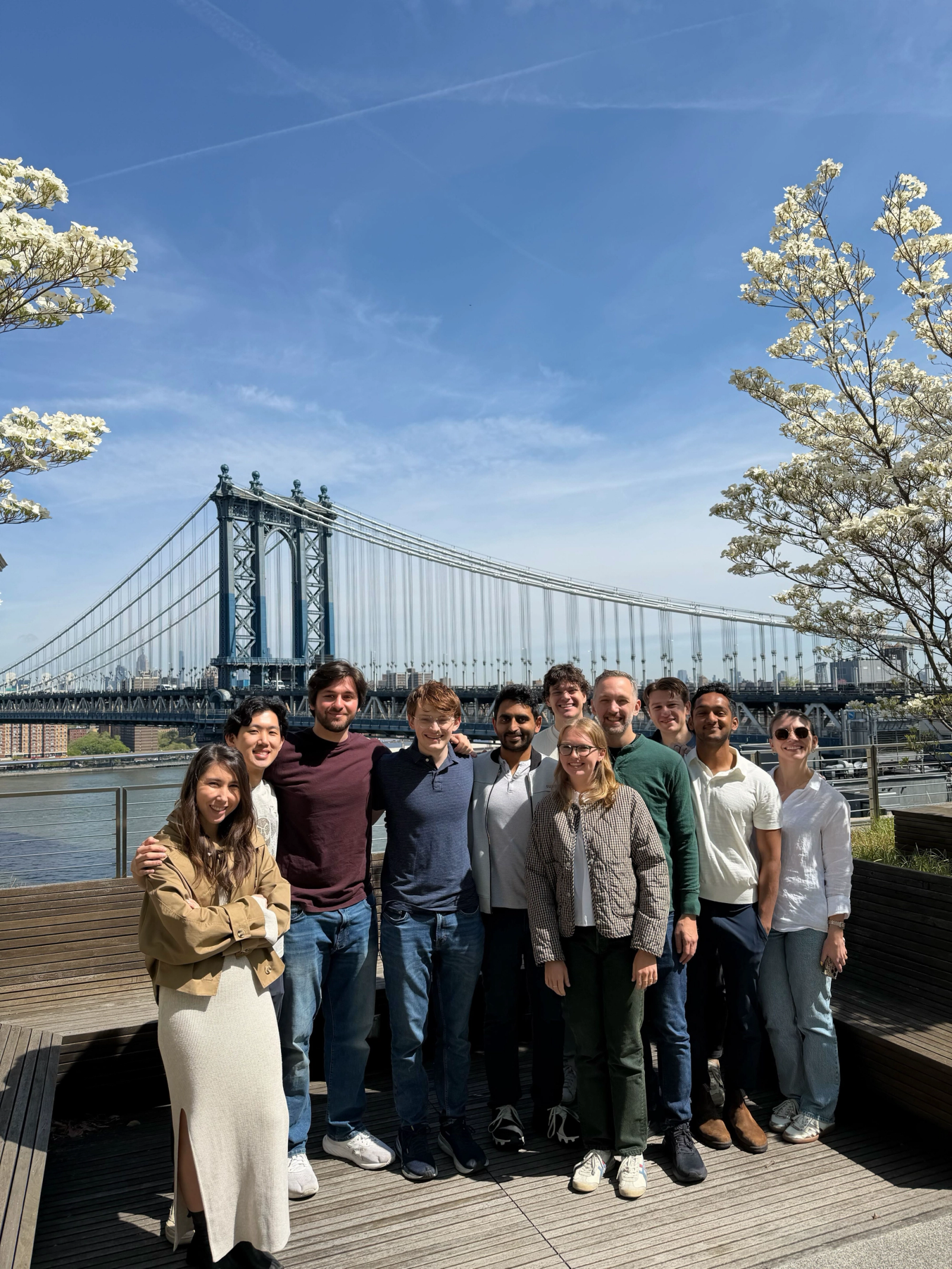 Nuvo colleagues on a riverside walk in front of the Manhattan Bridge