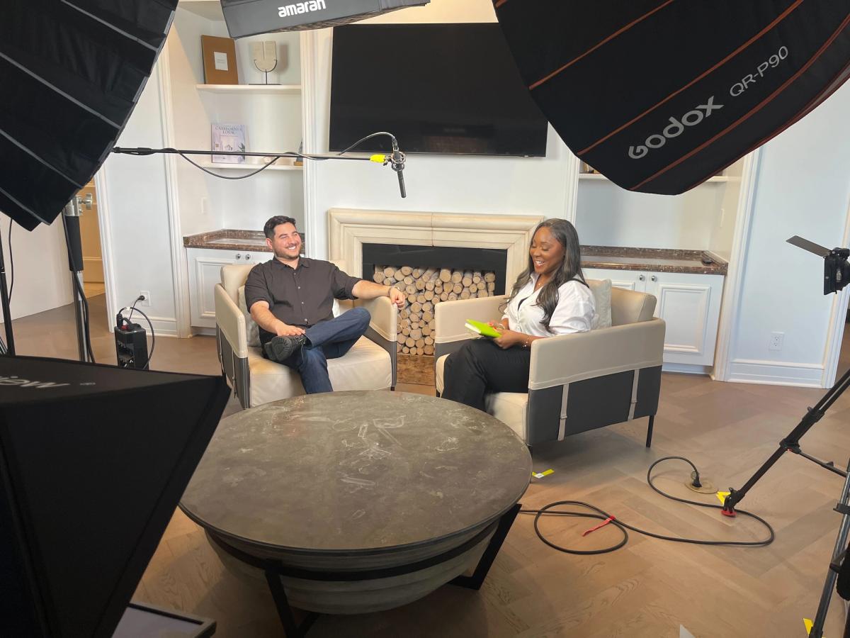 Tavily CEO Rotem Weiss sits in a room with podcast host Markiesha Ollison under production lights.