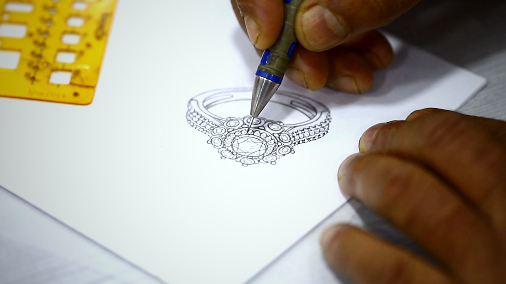 Designer sketching a ring on paper