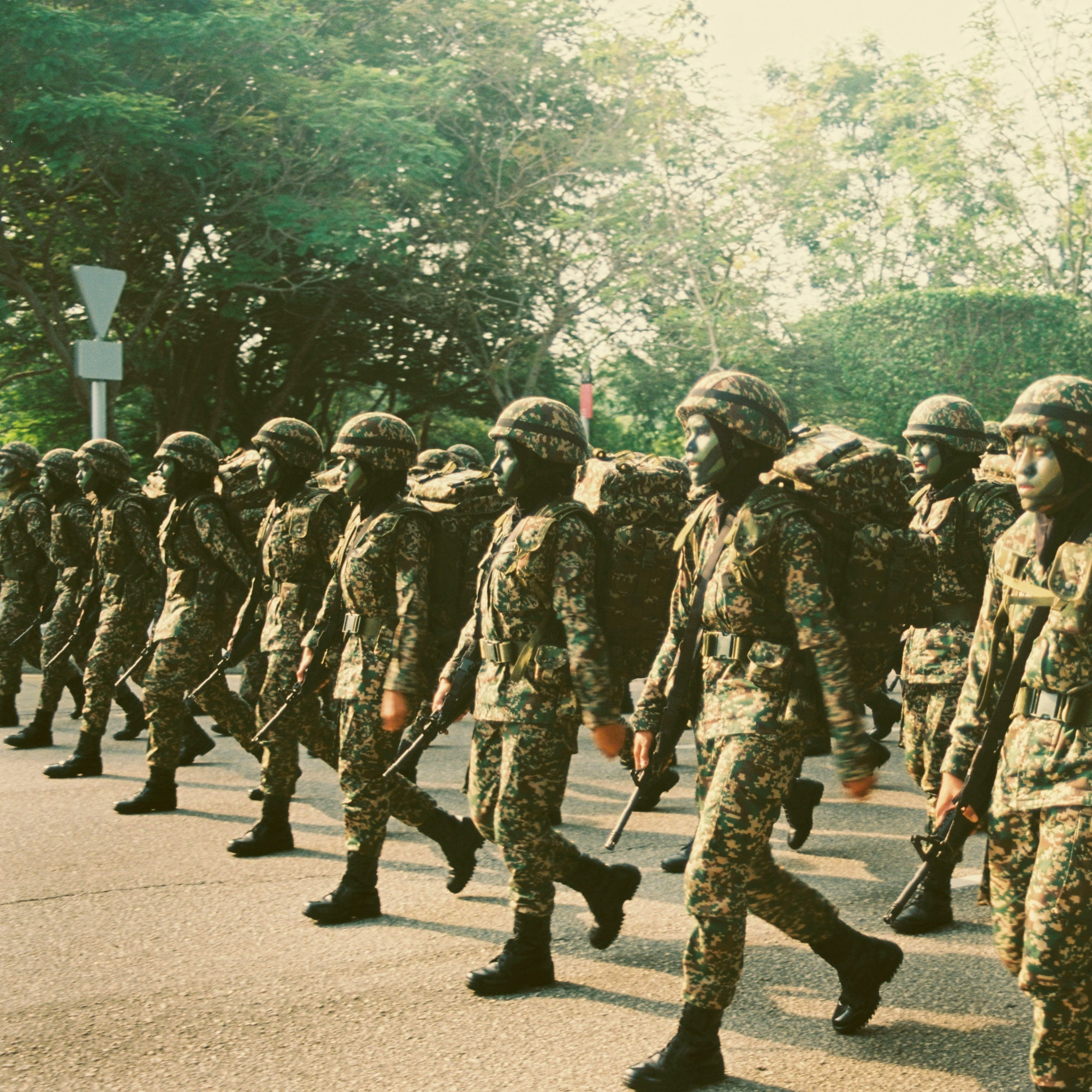 Two lines of people face each other, police on one side and citizens on the other