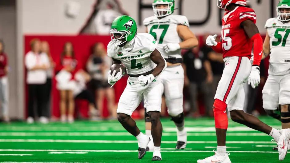 A North Dakota ball carrier runs with the football as a South Dakota defender closes in at the DakotaDome during South Dakota's 26-23 overtime win on October 24, 2026.