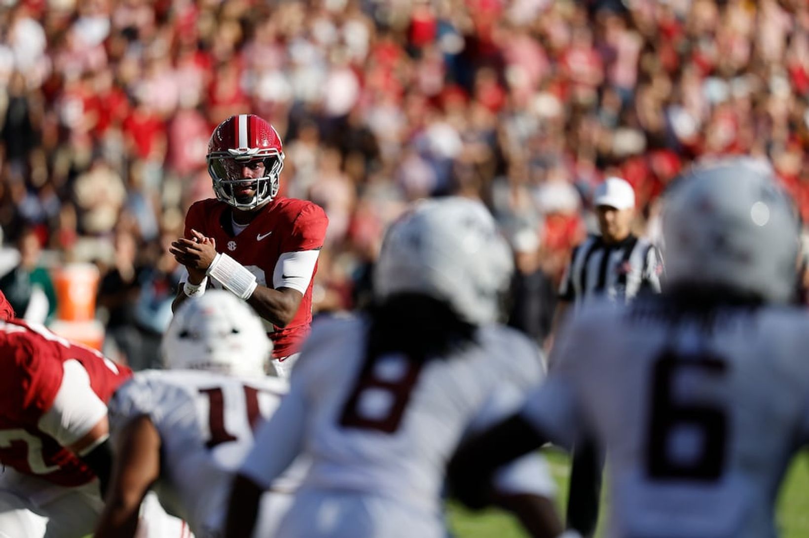 Alabama quarterback Keelon Russell (12) waits for the snap with Texas A&M defenders in the foreground during Alabama's 31-20 win over Texas A&M at Bryant-Denny Stadium on Oct. 24, 2026.