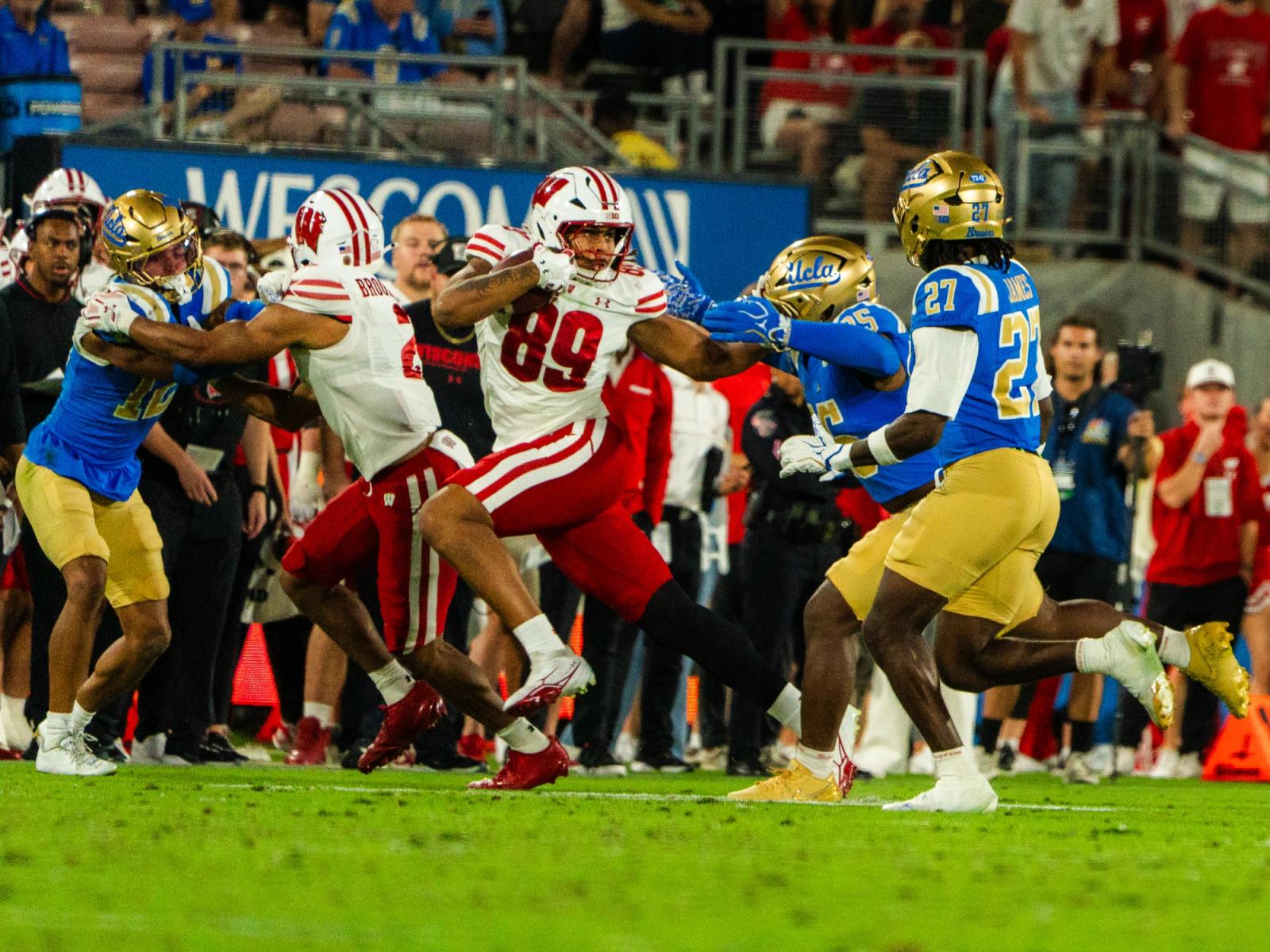 Wisconsin tight end runs with the ball as UCLA defenders close in at the Rose Bowl