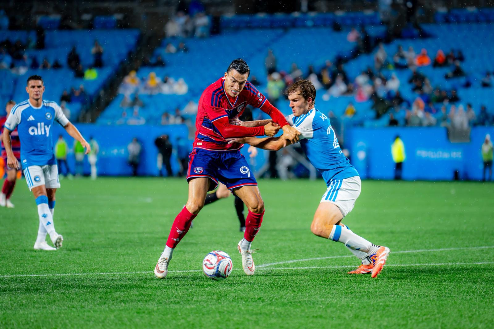 Charlotte FC and FC Dallas players battle for possession in the rain. Photo Credit: Arturo Rosales Sevilla/Undrafted