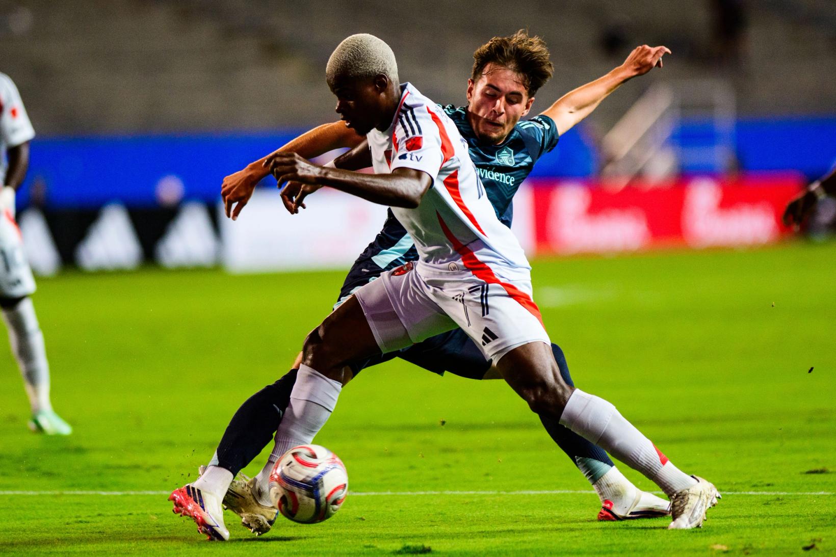 FC Dallas player shields the ball from a Seattle Sounders player at Toyota Stadium — Photo Credit: Luis Revilla Mata/Undrafted