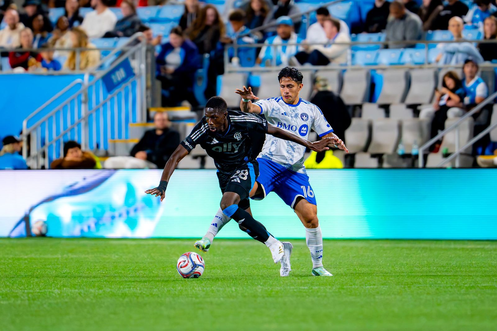 A Charlotte FC player dribbles past a CF Montréal defender at Bank of America Stadium — Photo Credit: Arturo Rosales Sevilla/Undrafted