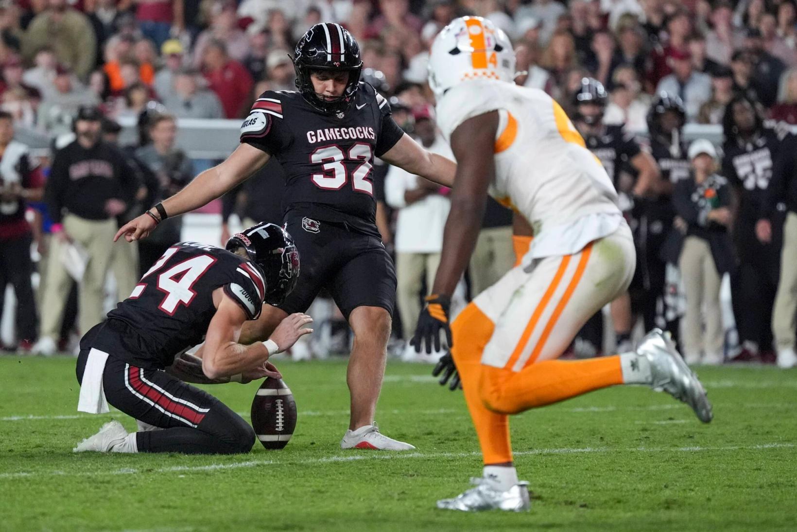 South Carolina kicker Malik Orsan (32) kicks a field goal from the hold of Mason Love (24) as a Tennessee defender rushes during South Carolina's 27-24 win over Tennessee at Williams-Brice Stadium on Oct. 24, 2026.