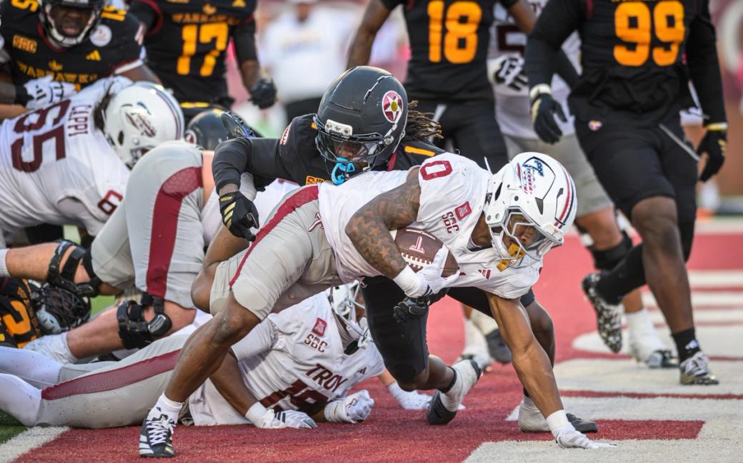 Troy running back Gavin Griffin (0) stretches toward the goal line as ULM defenders close in during ULM's 21-14 win at Troy's Veterans Memorial Stadium on Oct. 24, 2026.