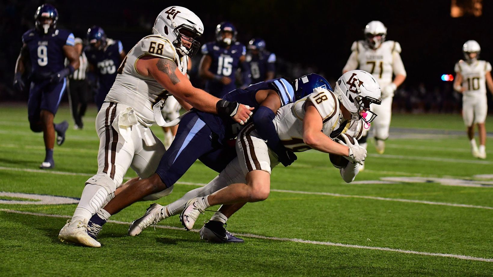 Lehigh receiver Bryce Werner (18) secures a catch as a Villanova defender drags him down at night during Villanova's 24-18 win over Lehigh at Villanova Stadium on Oct. 24, 2026