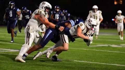 Lehigh receiver Bryce Werner (18) secures a catch as a Villanova defender drags him down at night during Villanova's 24-18 win over Lehigh at Villanova Stadium on Oct. 24, 2026