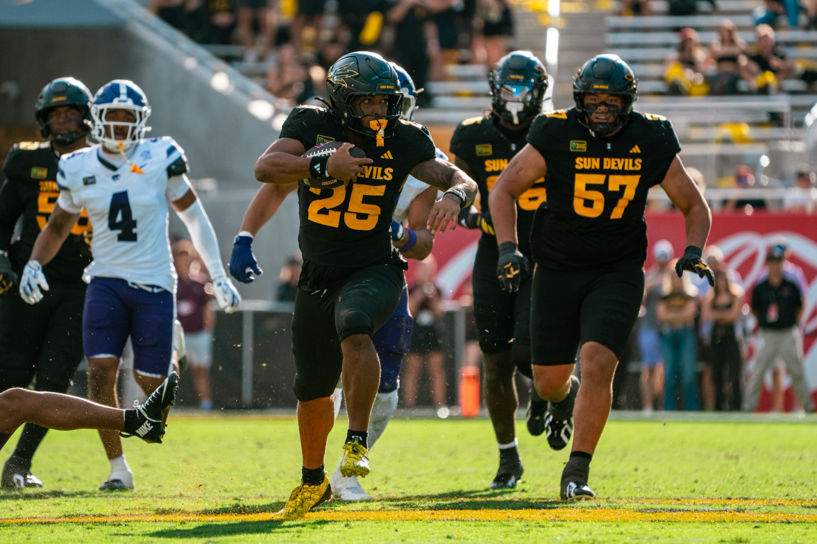 Arizona State running back Cardae Mack (25) carries the ball with teammates trailing and a Kansas State defender in pursuit during Arizona State's 28-17 win over Kansas State at Mountain America Stadium on Oct. 24, 2026.