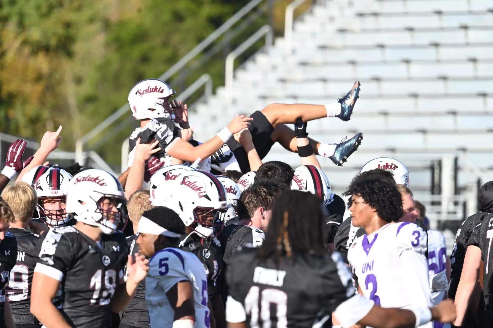 Weston Schofield is tossed into the air after kicking the game-winning field goal against Northern Iowa at Saluki Stadium