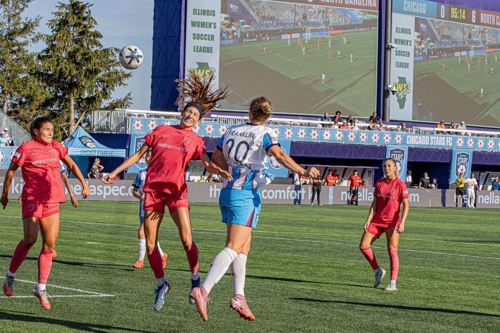 A North Carolina Courage player and Chicago Stars FC defender Franklin battle for a header late in the September 6, 2026 match at Martin Stadium, with the scoreboard showing a 6-0 Courage lead.