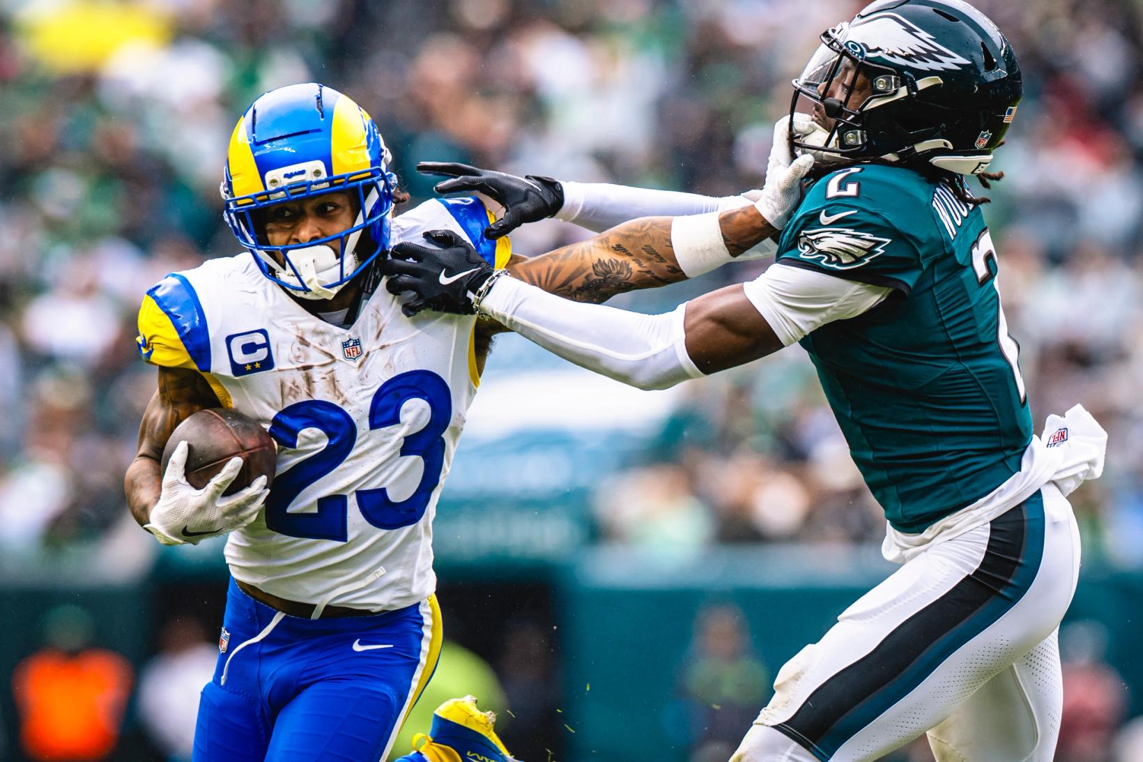 Los Angeles Rams running back Kyren Williams (23) carries the ball as a Philadelphia Eagles defender reaches for him.