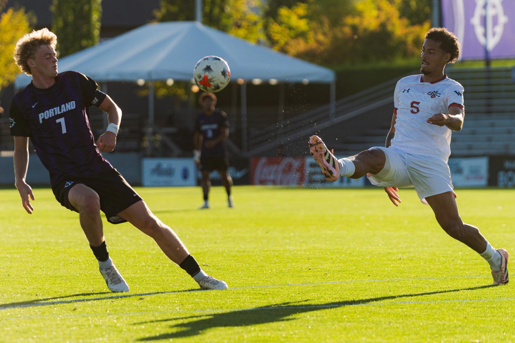 Players battle for the ball in mid-air during Portland Pilots vs Saint Mary's — Photo Credit: Aaron Leopold/Undrafted