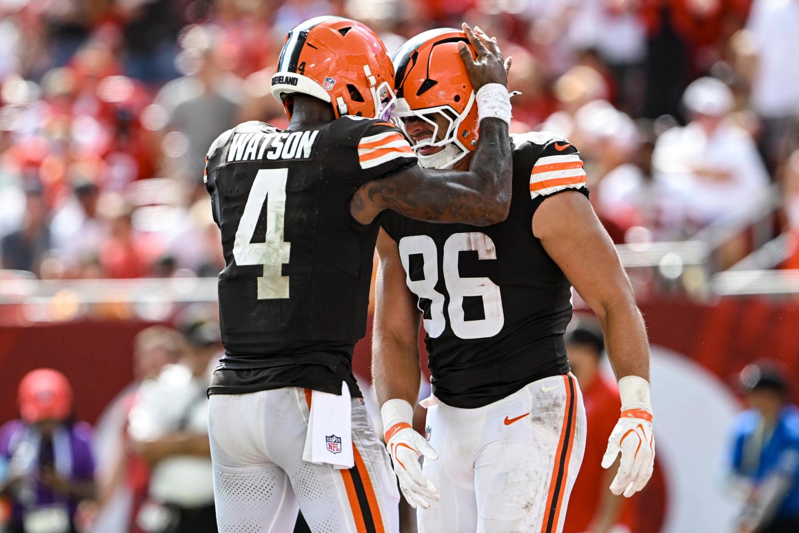 Cleveland Browns quarterback Deshaun Watson (4) puts his hand on the helmet of tight end Blake Whiteheart (86) as they celebrate at Raymond James Stadium
