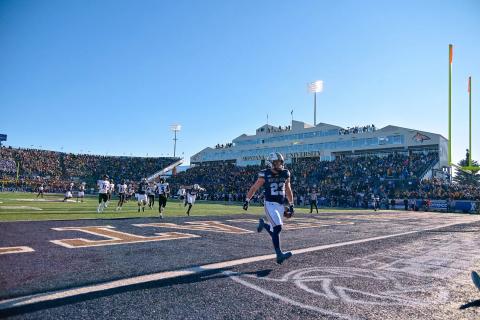 File photo of Montana State running back Adam Jones scoring a touchdown, shown in a wide angle view
