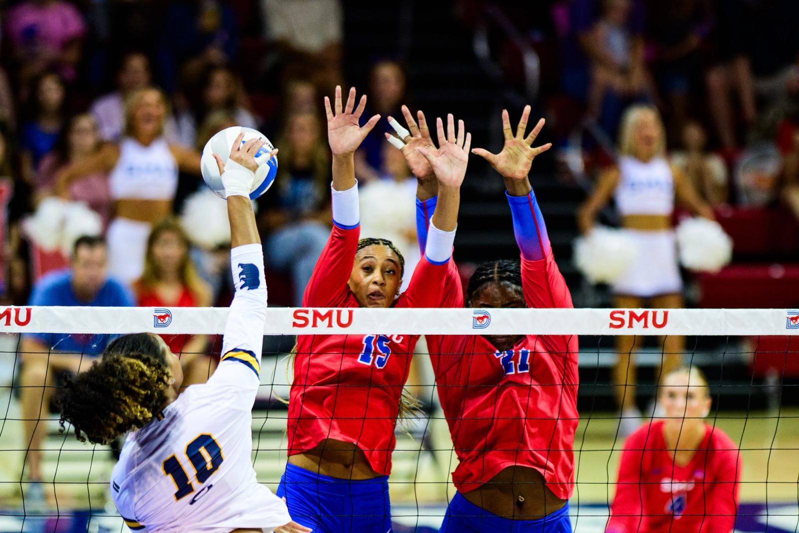 Photo Credit: Luis Revilla Mata/Undrafted — SMU #15 and #21 form a double block against a Cal #10 attack