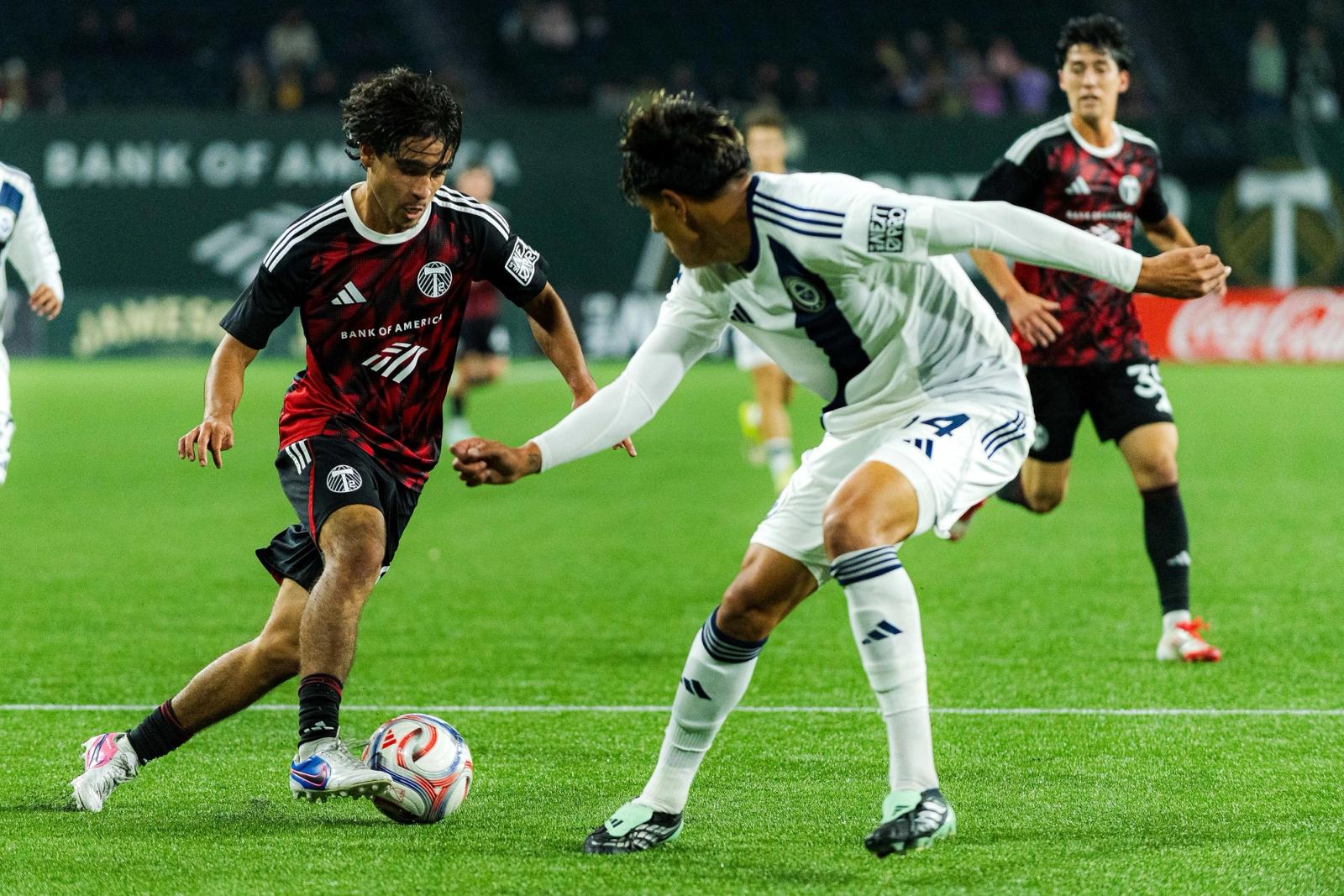 A Portland Timbers2 player and a Ventura County FC player challenge for the ball at Providence Park on October 25, 2026.