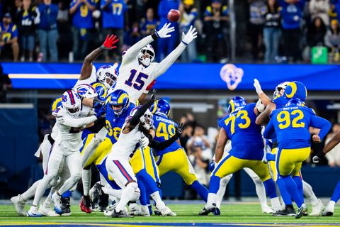 Buffalo Bills outside linebacker Greg Rousseau (15) leaps with both arms raised as Los Angeles Rams kicker Harrison Mevis (92) kicks the ball at SoFi Stadium