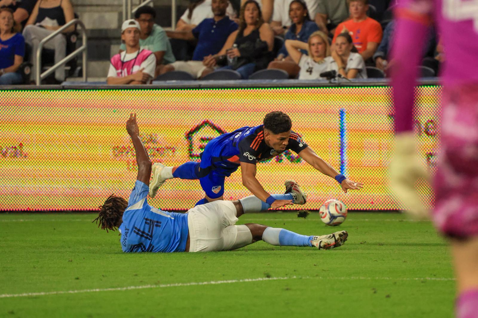 An FC Cincinnati player and a New York City FC player battle for the ball during the August 19, 2026 match at TQL Stadium.
