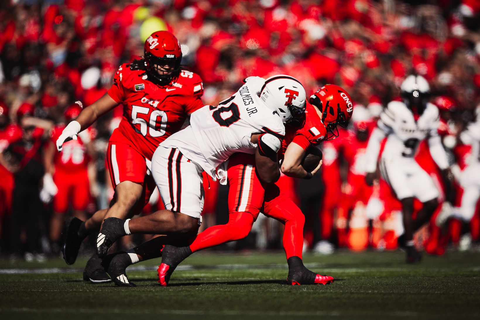 Texas Tech's A.J. Holmes Jr. sacks the Cincinnati quarterback in front of a red-clad Nippert Stadium crowd during Cincinnati's 37-24 win over No. 8 Texas Tech on Oct. 24, 2026.