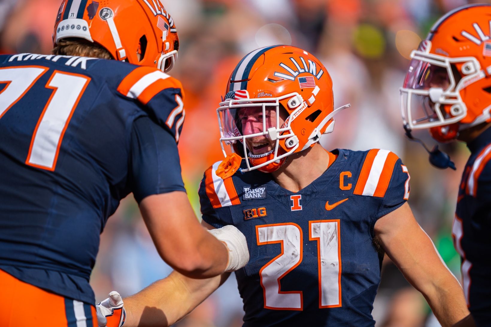 Illinois running back Aidan Laughery, No. 21, celebrates with teammate No. 71 during the 21-10 win over Oregon at Gies Memorial Stadium on Oct. 24, 2026