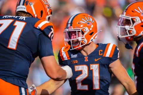Illinois running back Aidan Laughery, No. 21, celebrates with teammate No. 71 during the 21-10 win over Oregon at Gies Memorial Stadium on Oct. 24, 2026