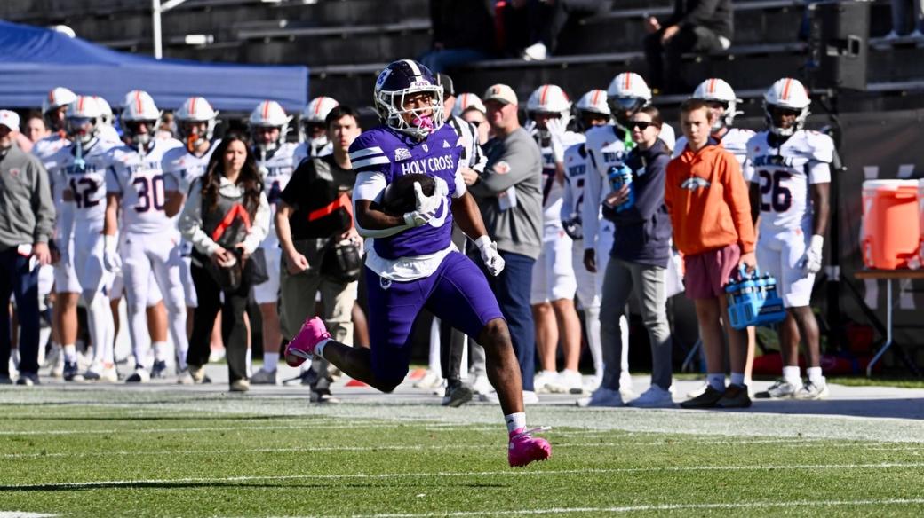 Holy Cross running back Jojo Williams carries the ball down the sideline past the Bucknell bench at Fitton Field during Holy Cross's 34-3 Homecoming win on Oct. 24, 2026
