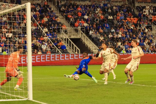 An FC Cincinnati attacker stretches for a shot in front of the D.C. United goal during the October 21, 2026 match at TQL Stadium.