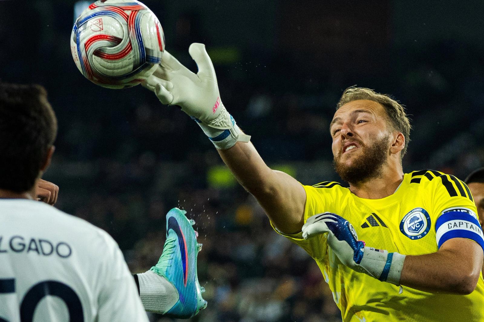 A goalkeeper in yellow stretches to punch the ball clear during the MLS NEXT Pro Western Conference Semifinal between Portland Timbers2 and Ventura County FC at Providence Park on October 25, 2026.
