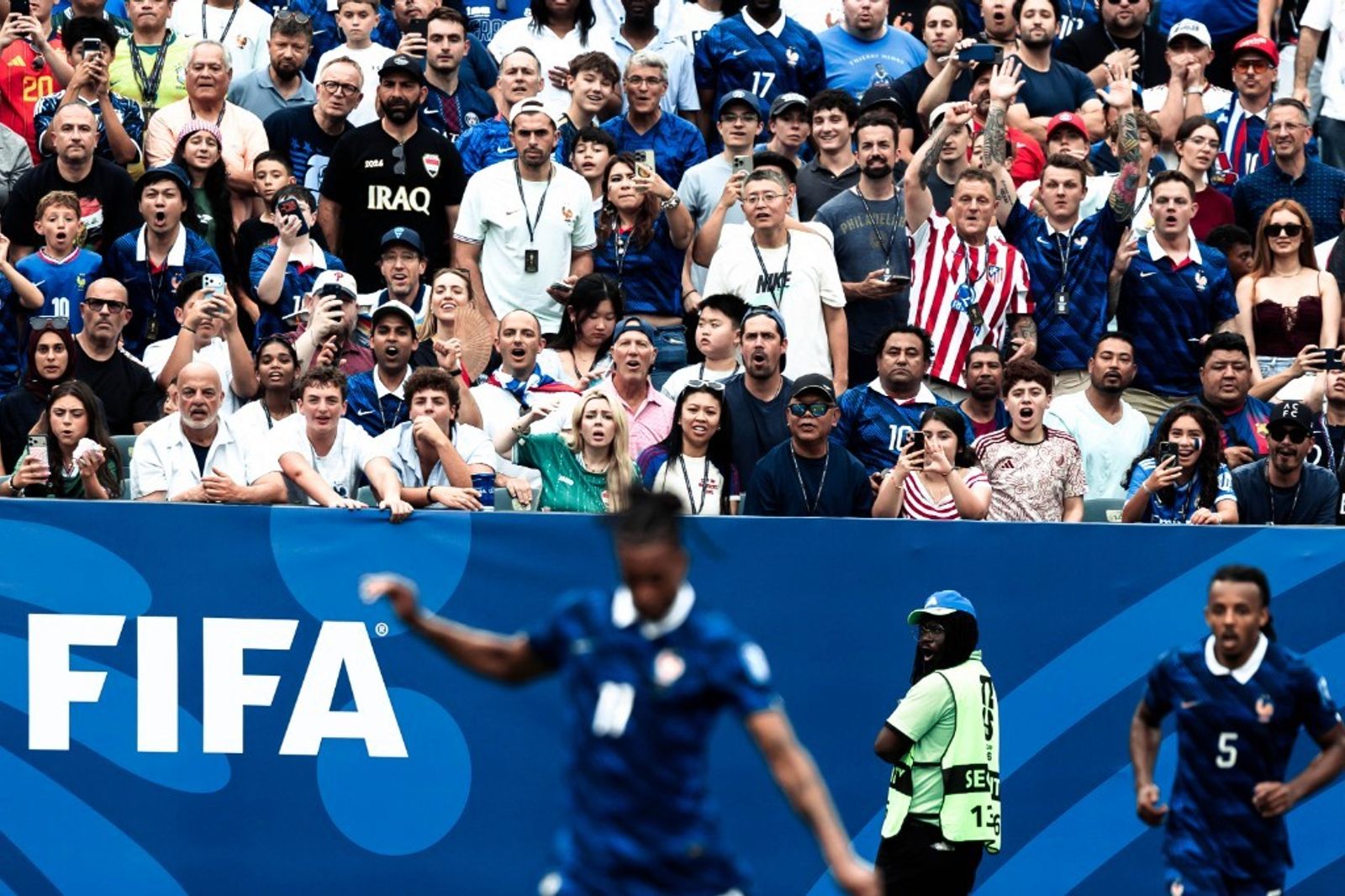 Jules Koundé runs along the touchline as Iraq fans pack the stands at the 2026 FIFA World Cup