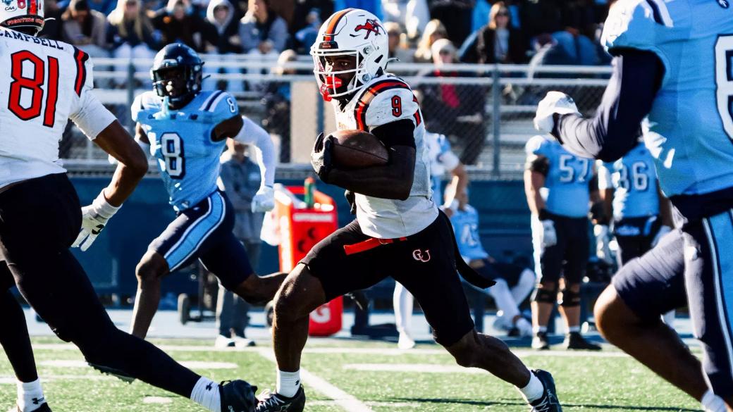 Campbell receiver Jyron Waiters, No. 9 in white, runs with the ball past Maine defenders in light blue during Campbell's 35-6 win at Alfond Stadium in Orono on Oct. 24, 2026