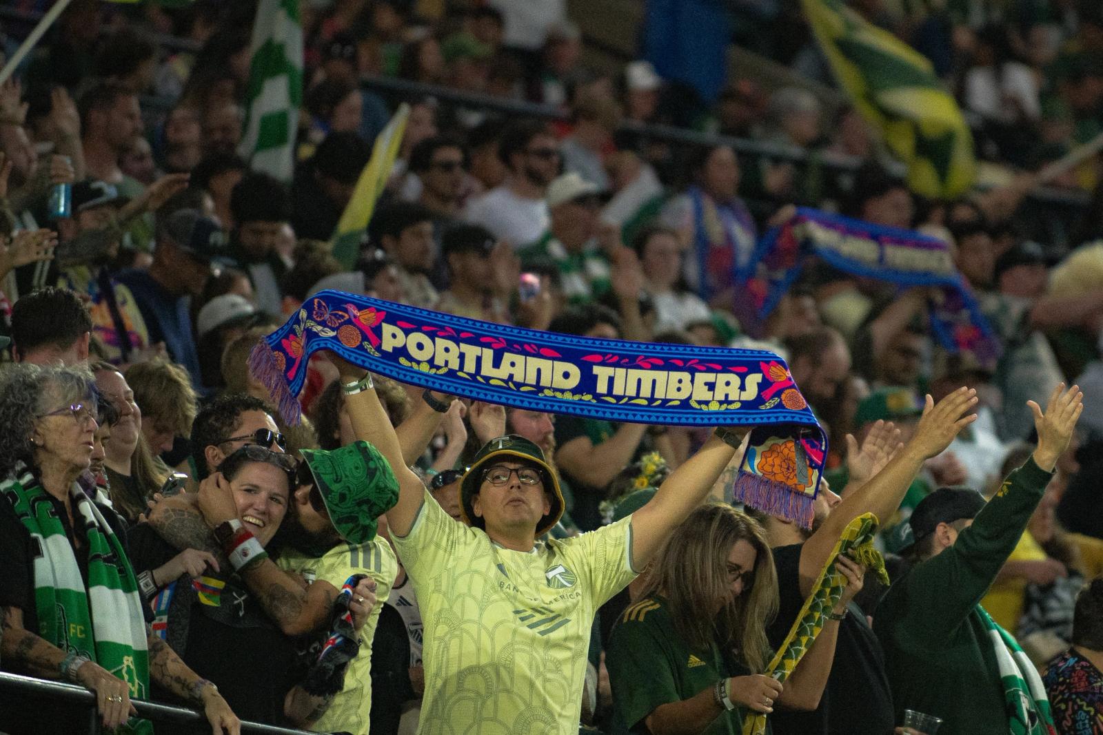 Portland Timbers fans hold up a scarf in the stands at Providence Park — Photo Credit: Aaron Leopold/Undrafted