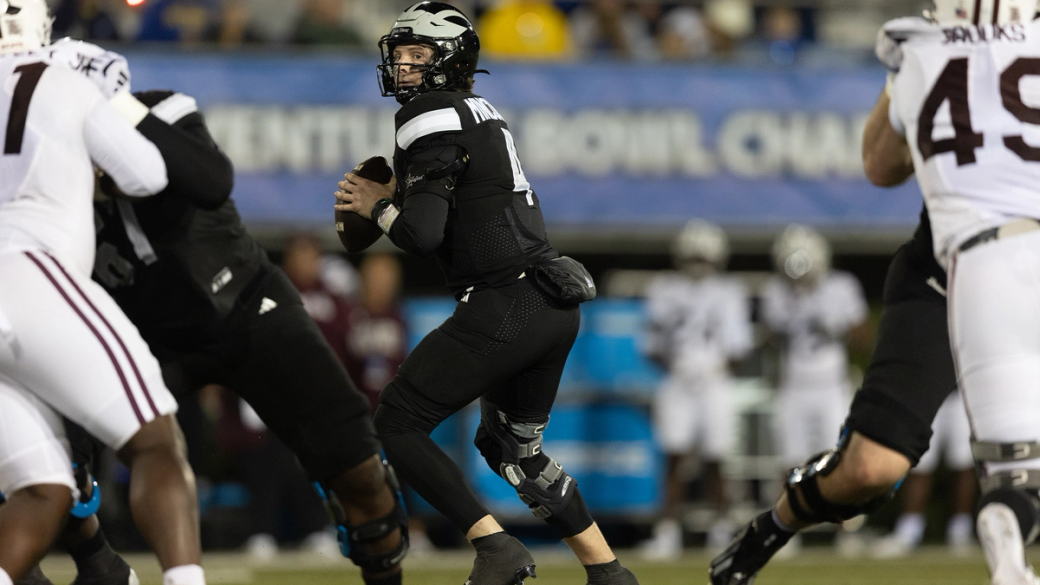 Delaware quarterback Nick Minicucci, in a black uniform, drops back to pass against Missouri State on Oct. 20, 2026