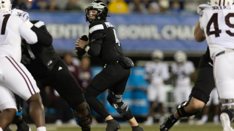 Delaware quarterback Nick Minicucci, in a black uniform, drops back to pass against Missouri State on Oct. 20, 2026