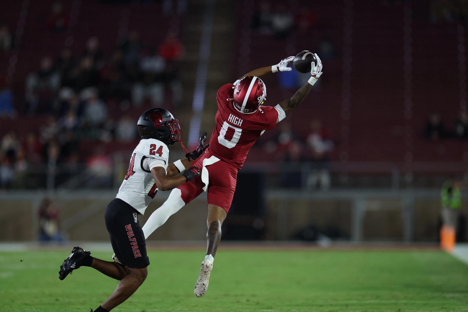 Stanford receiver Caden High, No. 0 in red, leaps for a catch over NC State defender No. 24 during Stanford's 31-28 win at Stanford Stadium on Oct. 23, 2026.