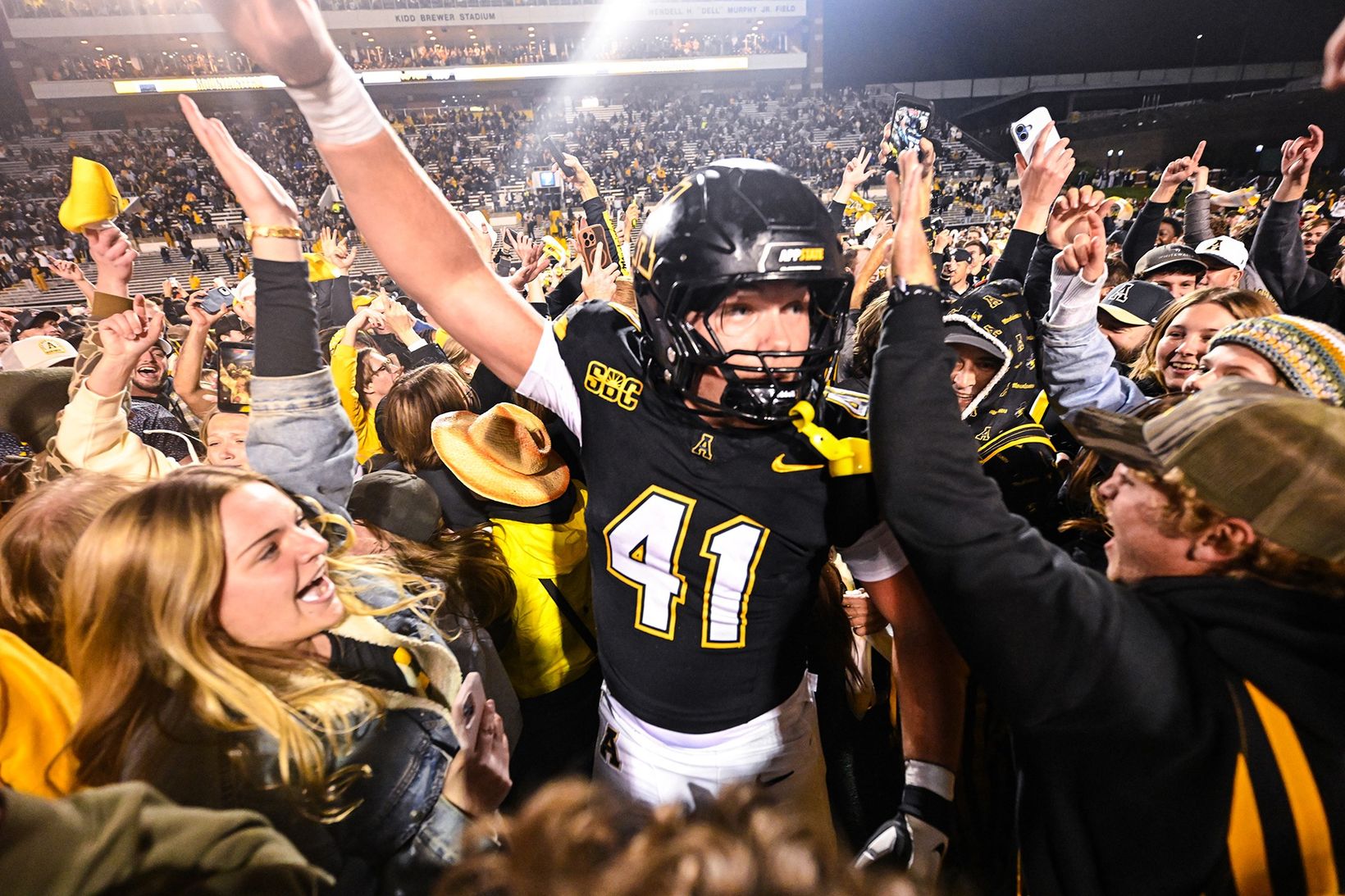 App State defensive lineman Caleb Sandstrom, No. 41, celebrates with fans on the field at Kidd Brewer Stadium after the Mountaineers beat James Madison 34-31 in overtime on Oct. 22, 2026.