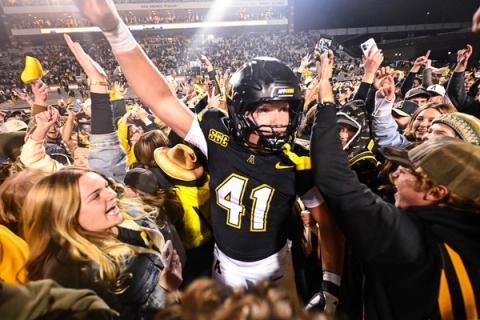 App State defensive lineman Caleb Sandstrom, No. 41, celebrates with fans on the field at Kidd Brewer Stadium after the Mountaineers beat James Madison 34-31 in overtime on Oct. 22, 2026.