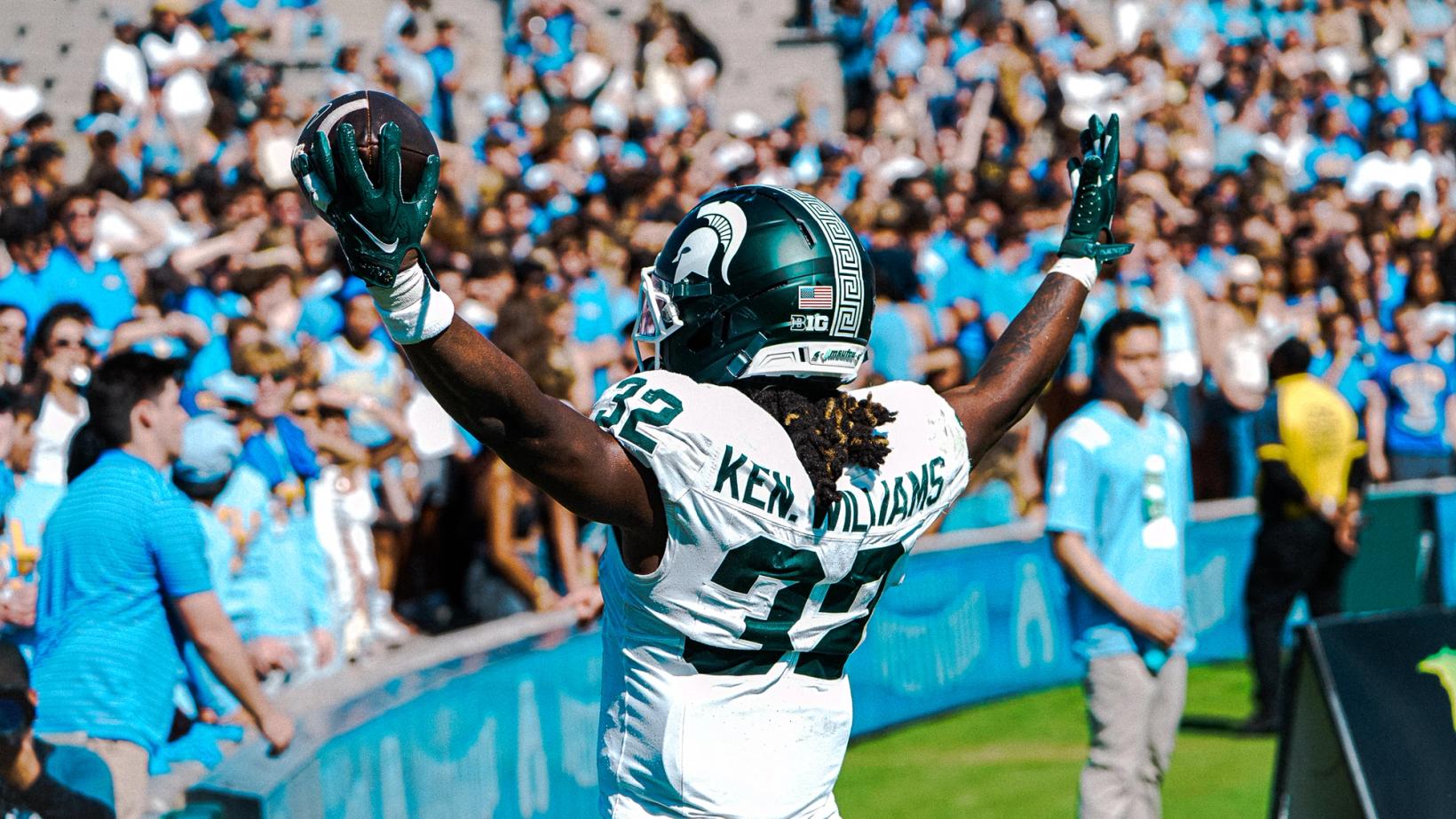 Michigan State running back Kenneth Williams, No. 32, raises the football and his arms in front of UCLA fans at the Rose Bowl on October 24, 2026.