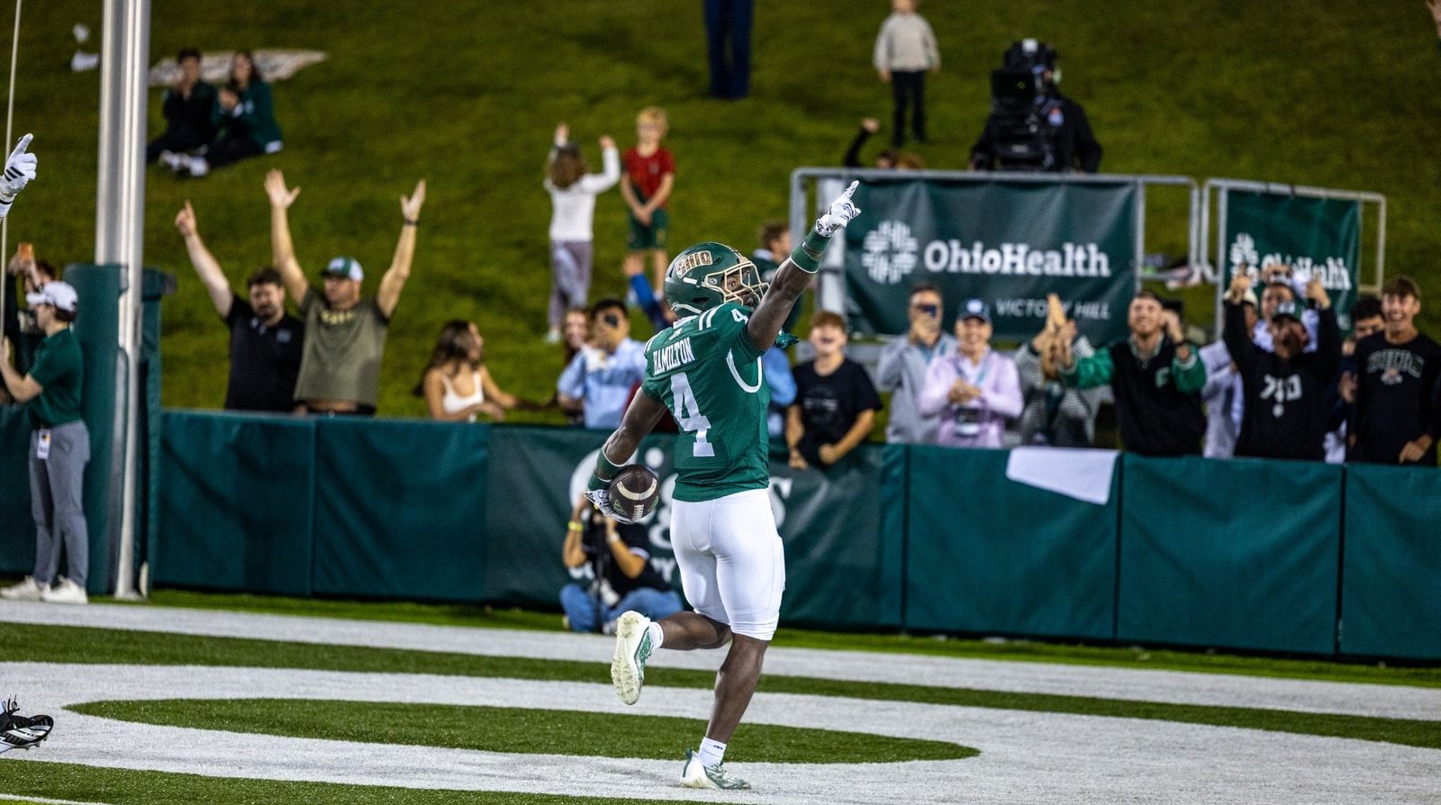 Ohio's Darren James-Hamilton (4) points skyward as he celebrates in the end zone with the ball while fans cheer behind him during Ohio's 24-20 win over Eastern Michigan at Peden Stadium on Oct. 24, 2026.