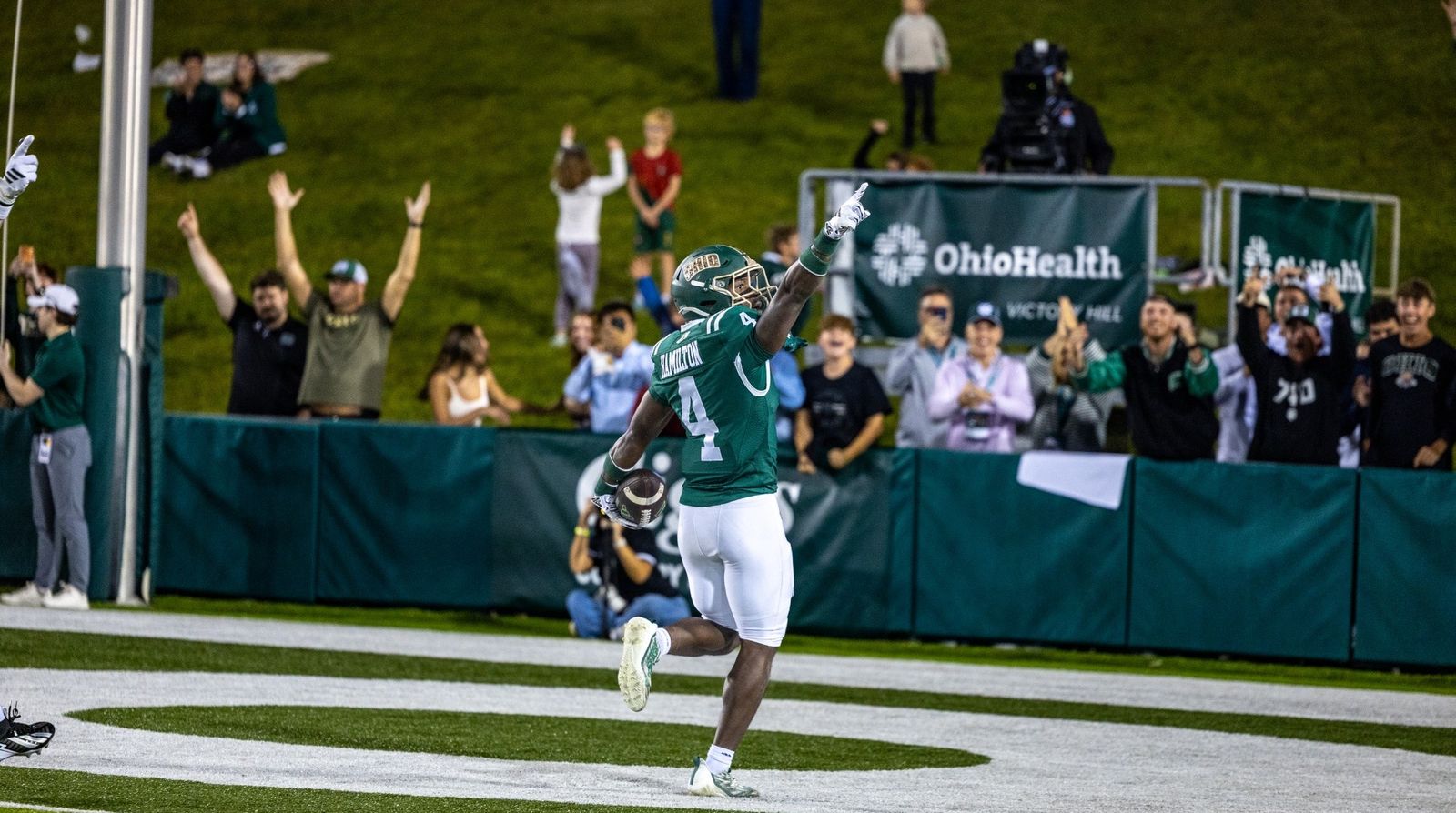Ohio's Darren James-Hamilton (4) points skyward as he celebrates in the end zone with the ball while fans cheer behind him during Ohio's 24-20 win over Eastern Michigan at Peden Stadium on Oct. 24, 2026.