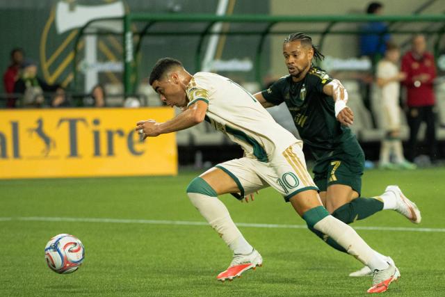 Atlanta United player races a Portland Timbers defender to the ball — Photo Credit: Aaron Leopold/Undrafted